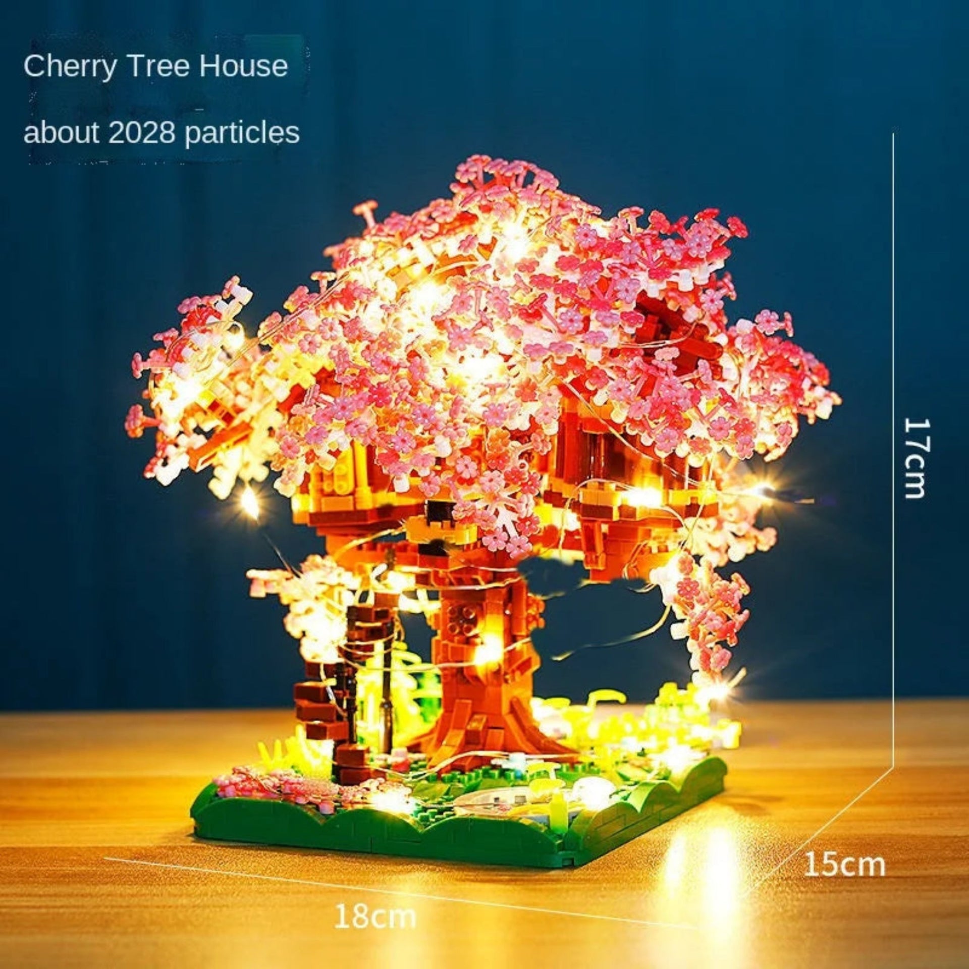 Cherry tree house model with LED lights on a wooden surface and dark blue background