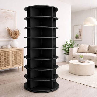 Black spiral bookshelf in a living room setting with a couch and coffee table.