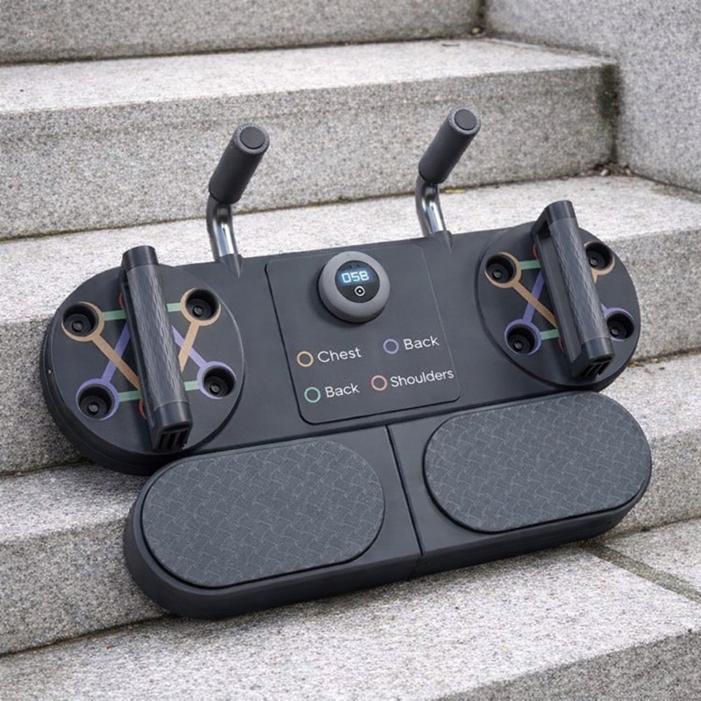 Black gaming controller with USB port and button layout on a stone step