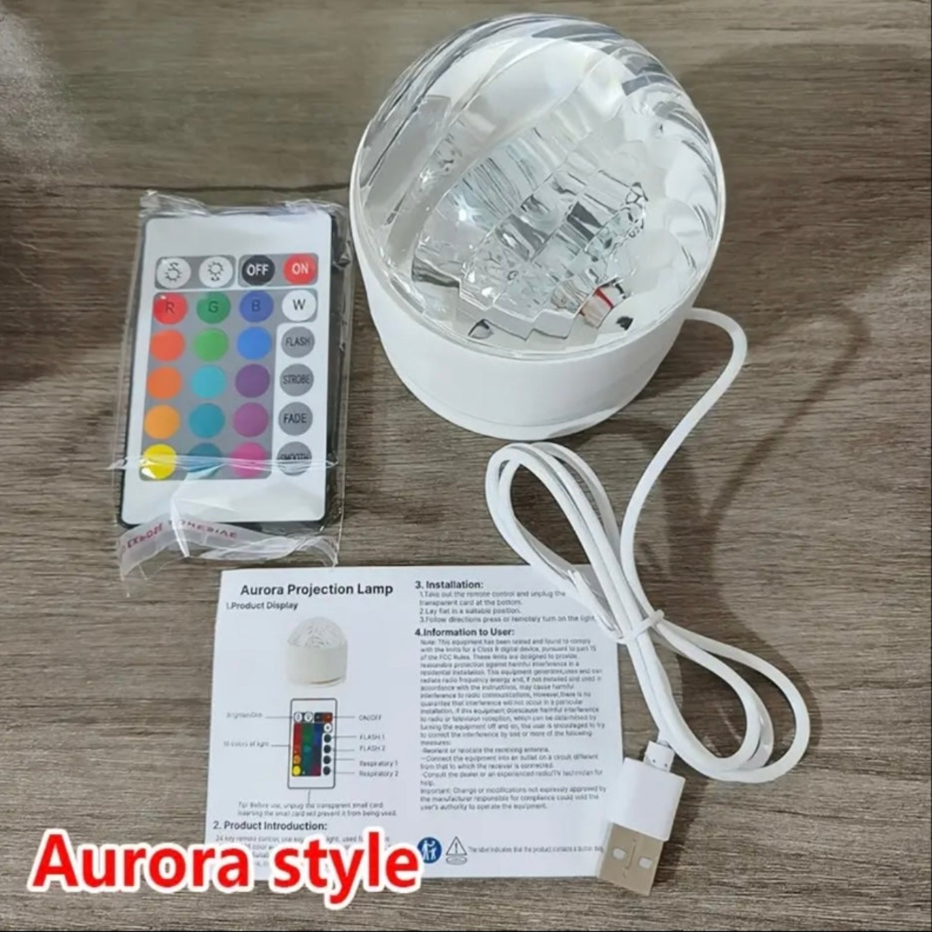 Aurora Galaxy Projector shown with remote control, USB cable, and user manual on a wooden surface