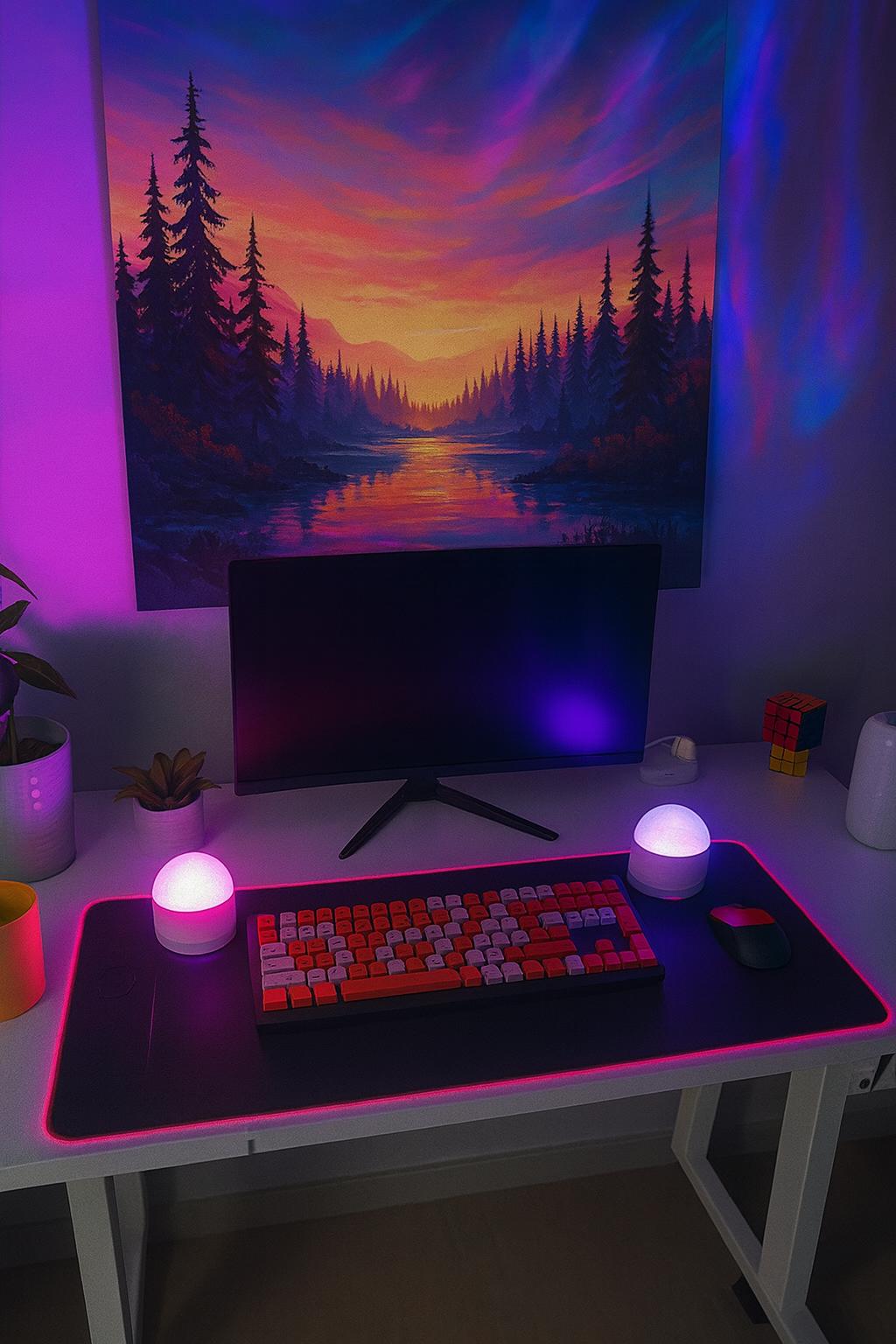 Modern home office setup with a desk, 2 Aurora projector lamps, a computer monitor, a keyboard, and decorative wall art.