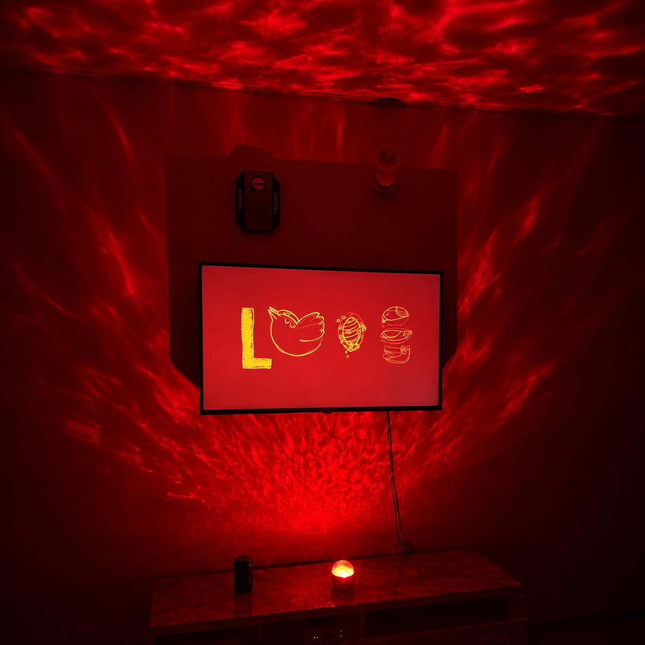 Red LED sign with 'LOVE' and food illustrations on a dark background