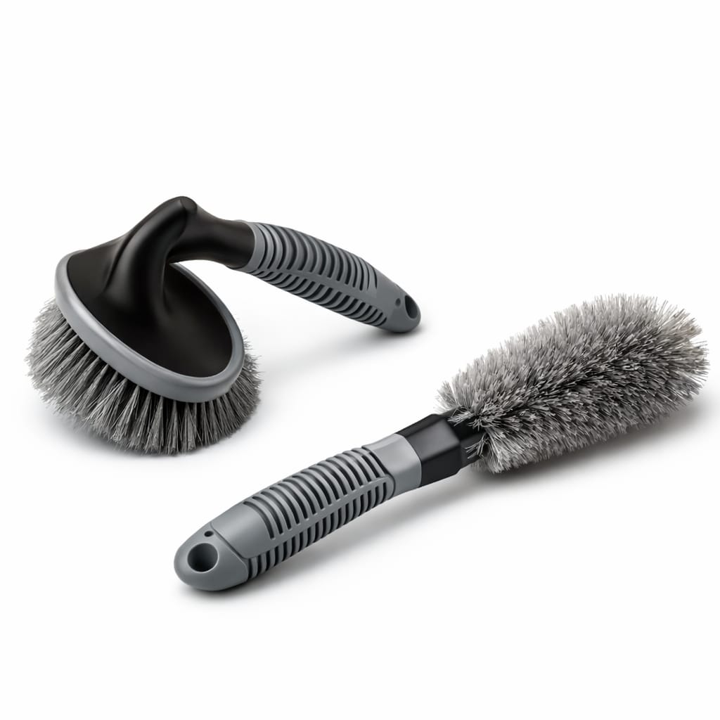 Two car cleaning brushes with gray bristles and black handles on a white background