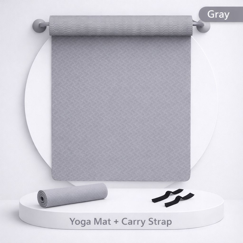 Gray yoga mat with carry strap on a white background