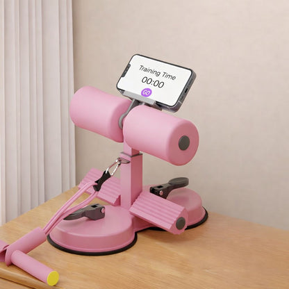 Pink assistive sit-up device with smartphone holder on a wooden surface