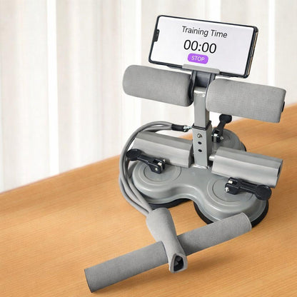 Gray assistive sit-up device with digital display on a wooden surface
