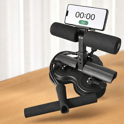Black assistive sit-up device with smartphone holder on a wooden surface